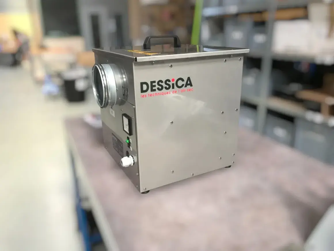 Un déshumidificateur DESSICA, idéal pour savoir quel déshumidificateur choisir. Appareil métallique avec une entrée d'air ronde et un panneau de contrôle.